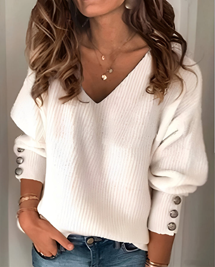 Fleur witte V-hals pullover, close-up mouwdetail